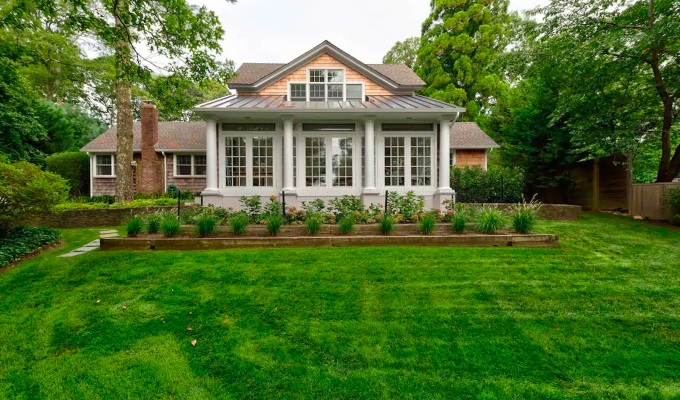Best Airbnbs in the Hamptons - A large house with a porch and a sprawling green lawn.