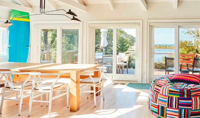 Best Airbnbs in the Hamptons - A bright living room in a Hamptons home that has a backyard that leads onto the ocean.