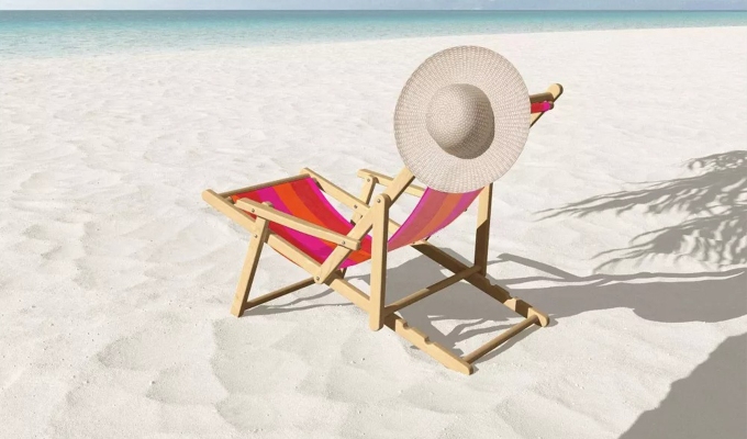 Best beach chairs: A red beach chair with a hat on the back of it