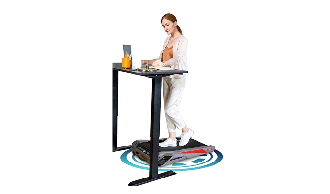 Best under-desk treadmills: A model using a treadmill under her desk