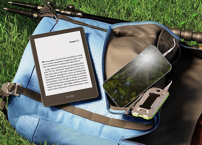 Best last-minute Father's Day gifts on amazon: A Kindle next to a backpack on the grass