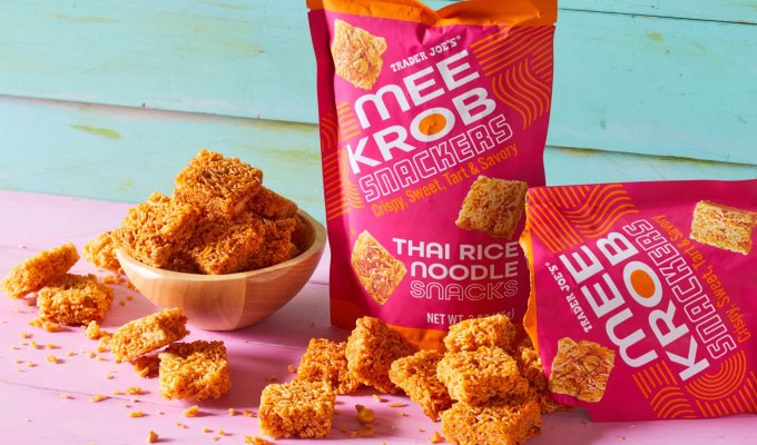 new at trader joe's june 2023: bowl of mee krob rice snacks next to two bags of the snacks