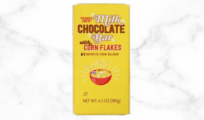 new at trader joe's june 2023: milk chocolate bar with corn flakes on a marble background